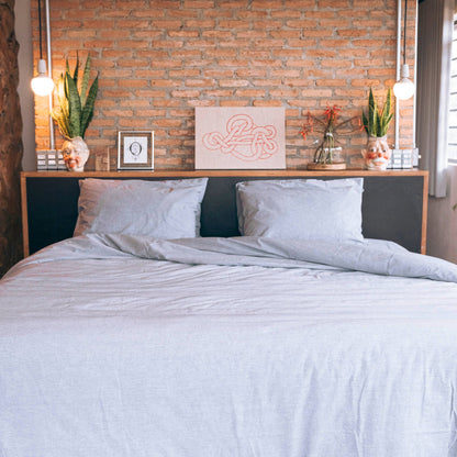 front view of king bed made with organic cotton percale bedding in grey